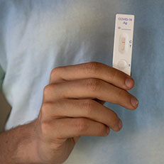 Person holding a COVID-19 test