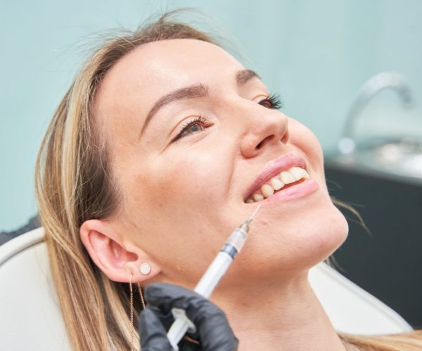 A Woman On A Cosmetic Treatment A closeup of a beautiful caucasian woman having a cosmetic procedure, filling wrinkles