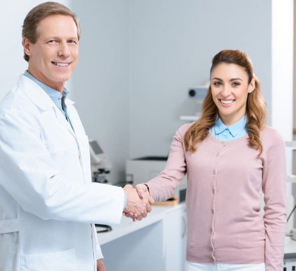 smiling-ophthalmologist-and-patient-shaking-hands-2024-11-19-16-12-35-utc